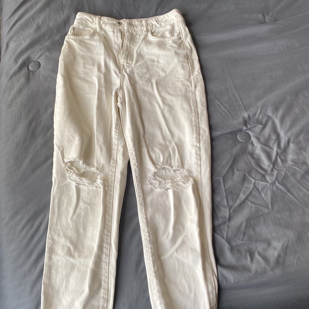 White Zara jeans. The trendy rips on both knees. Boot cut.